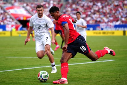Tim Payne (left) and Jude Bellingham battle for the ball during the friendly between England and New Zealand.