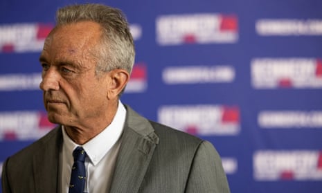a man with short grey hair and a grey suit and skinny blue tie