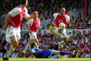 The 2003/04 season saw Arsenal and Wenger’s greatest achievement when the club ended the Premier League campaign as champions without a single defeat – a record of 26 wins and 12 draws. Here Thierry Henry passes to Dennis Bergkamp whilst jumping a tackle from Lilian Nalis during their 2-1 win over Leicester City on the last game of the season.