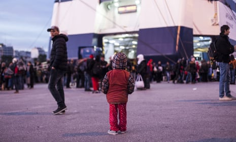 A child waits in front of the ferry in the Greek port of Piraeus, a busy hub for refugees seeking European entry.