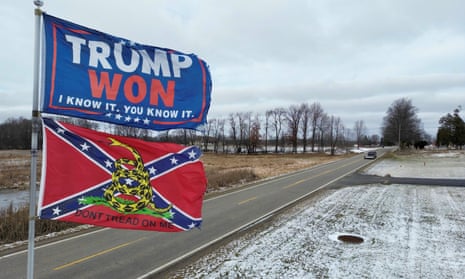 two flags on a snowy road, one says 'trump won'