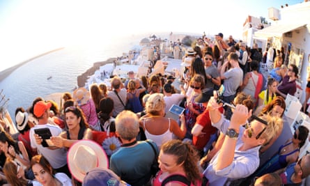 Crowd puller … tourists jostling for a sunset shot in Oia, Santorini.
