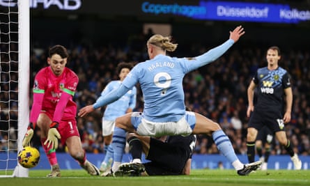 Erling Haaland sees his shot saved by James Trafford