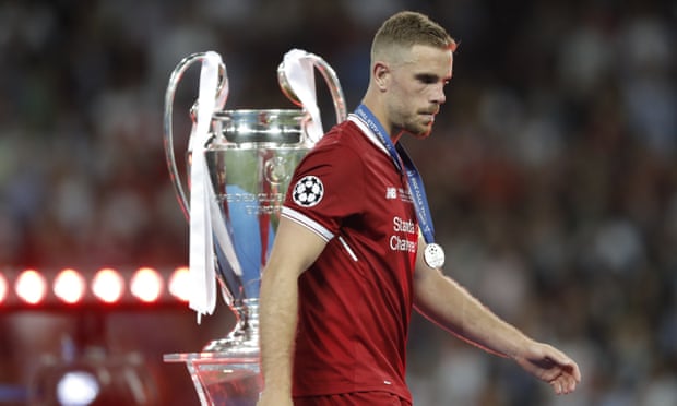 Jordan Henderson walks past the Champions League trophy after defeat by Real Madrid in the 2018 final.