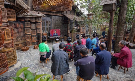 Villagers from ethnic minority, Danzhai, in south-western China, watch the 20th congress on TV.