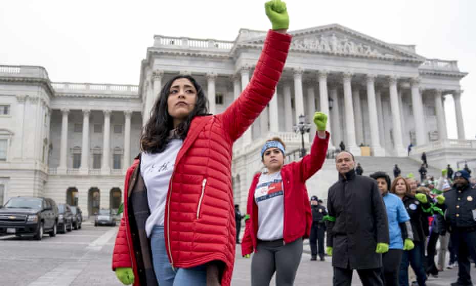 Demonstrators hold up their fists as they are arrested outside of the US Capitol during an immigration rally in support of the Deferred Action for Childhood Arrivals (Daca) and Temporary Protected Status (TPS) programs.