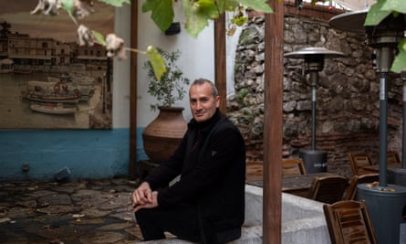 Şükrü Golak sitting outside under some trees in the Giritli restaurant