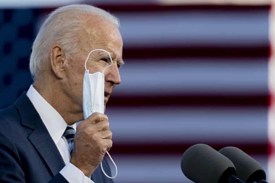 Joe Biden holds up his mask as he speaks in Gettysburg.