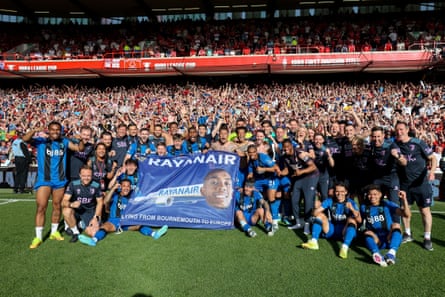 Bournemouth players sit around their âÂÂRayanairâ banner after qualifying for the Europa League