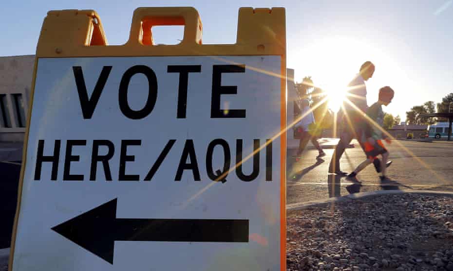 Voters come and go near a polling station at sunrise in Arizona’s presidential primary election on 22 March 2016 in Phoenix.