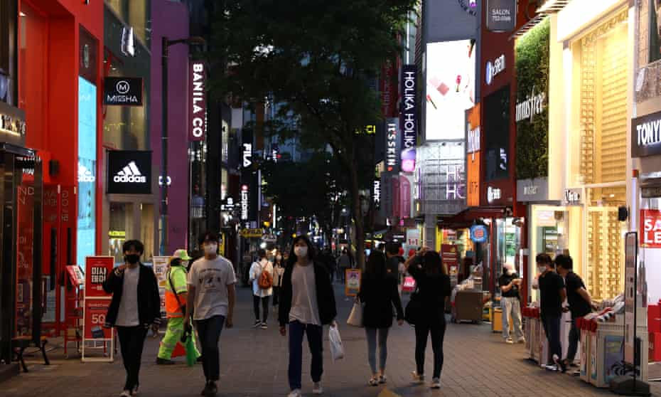 People walk along a street in Seoul. South Korea has won widespread praise for its ‘track and trace’ model of containing the pandemic