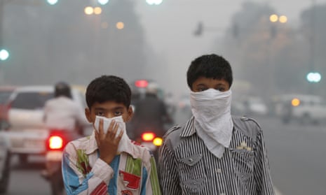 Children cover their face from air pollution in New Delhi, India.