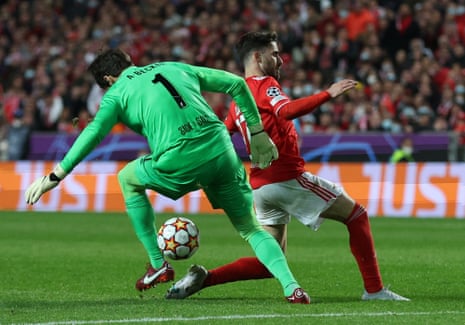 Liverpool’s Alisson in action with Benfica’s Rafa.