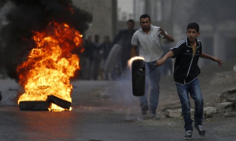 Palestinians set tyres alight during clashes with Israeli troops near the West Bank city of Hebron