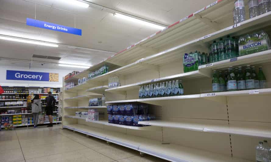 Near-empty shelves with limited supply of bottled water in supermarket