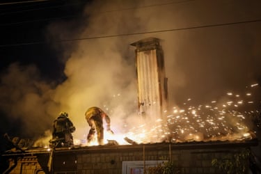 Firefighters on the roof of a house