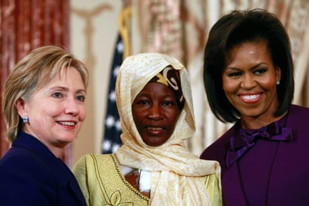 Hillary Clinton and Michelle Obama on either side of the former Nigerien slave