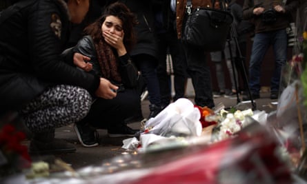 A woman reacts after placing flowers near the scene of the Bataclan theatre attack.