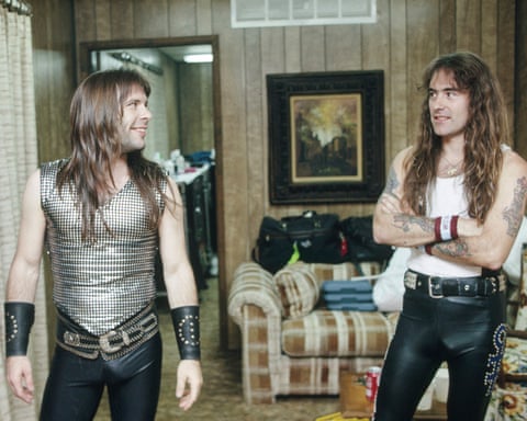 Bruce Dickinson with long hair and wearing leather trousers