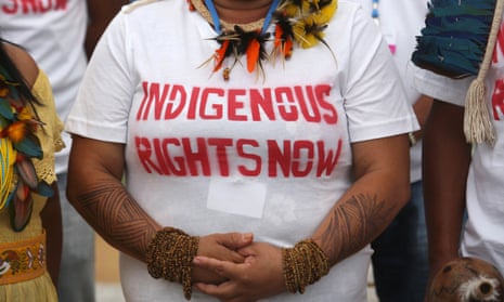 An Indian woman from the Brazilian Amazon in a T-shirt reading Indigenous rights now