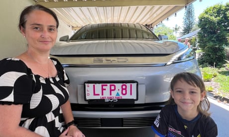 Gold Coast woman Kristy Holmes and her son Levi beside her BYD electric vehicle, which she has used to power his dialysis machine