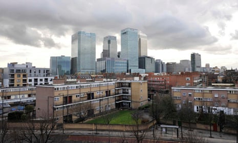 The Canary Wharf financial district seen behind social housing in Poplar, east London.