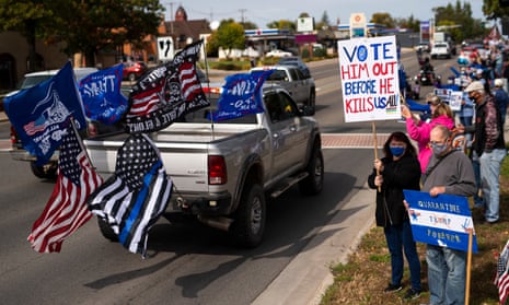Supporters of Donald Trump drive by a group supporting Joe Biden in Minnesota. 