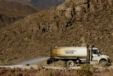 A water truck sprays near a construction site at the Tahoe‑Reno Industrial Center.