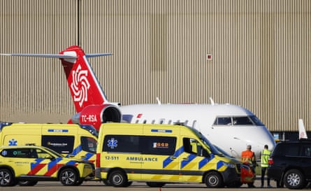 Ambulances alongside a plane.