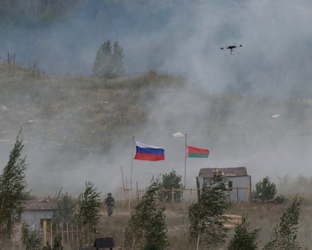 Russian and Belarusian flags fly at a training ground during Zapad-2025