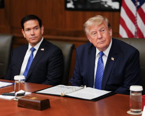 Trump and Rubio sit at a conference table during a cabinet meeting