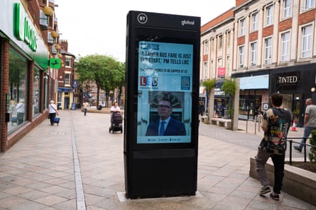 A news screen announces Burnham’s £2 bus fares cap.