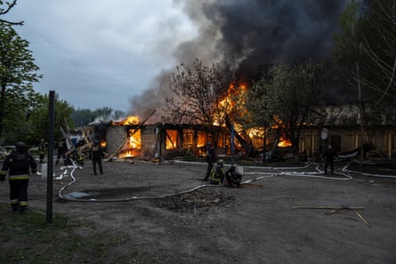 Firefighters working at scene as building burns