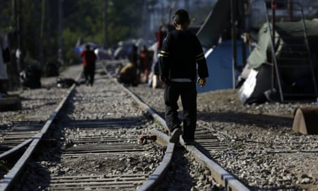 A child walks on the tracks in northern Greece