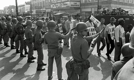 Memphis sanitation workers protest on 29 March 1968, watched by Tennessee National Guard troops with bayonets. Martin Luther King Jr was assassinated on 4 April while in Memphis supporting the strike.