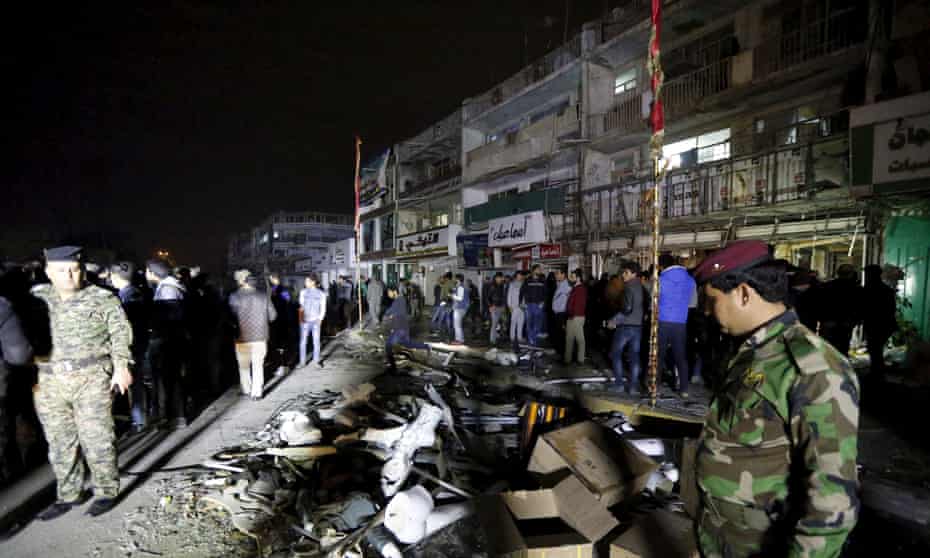 Wreckage from a car bomb outside a shopping mall in Baghdad on Monday. Seven people were killed in the bombing and another 11 died when gunmen entered the mall and opened fire on civilians. 