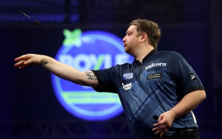 Cameron Menzies throws a dart during his quarter-final against Luke Humphries in World Grand Prix