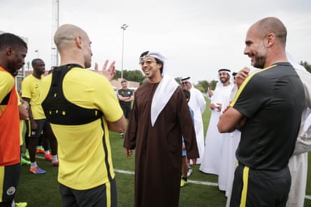 Sheikh Mansour laughs chatting with Pablo Zabaleta and Pep Guardiola on a training pitch