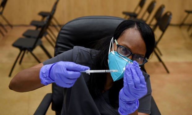 A healthcare worker prepares Covid vaccine doses in Houston, Texas.