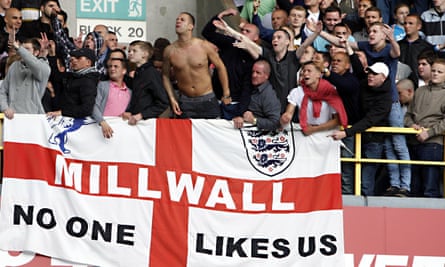 Millwall fans with a Cross of St George flag adorned with their slogan 'No one likes us'