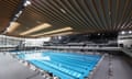 Light reflects off the wooden roof inside the aquatics centre