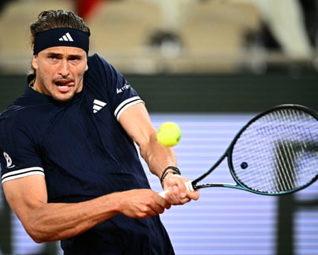 Alexander Zverev hits a two-handed backhand on a blue court