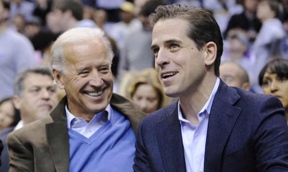 President Joe Biden, left, and his son Hunter Biden appear at the Duke Georgetown NCAA college basketball game in Washington on 30 January 2010. 