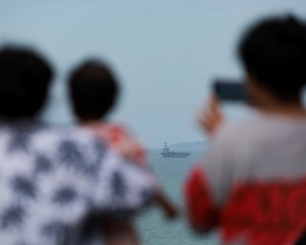 People watch as the ship approaches