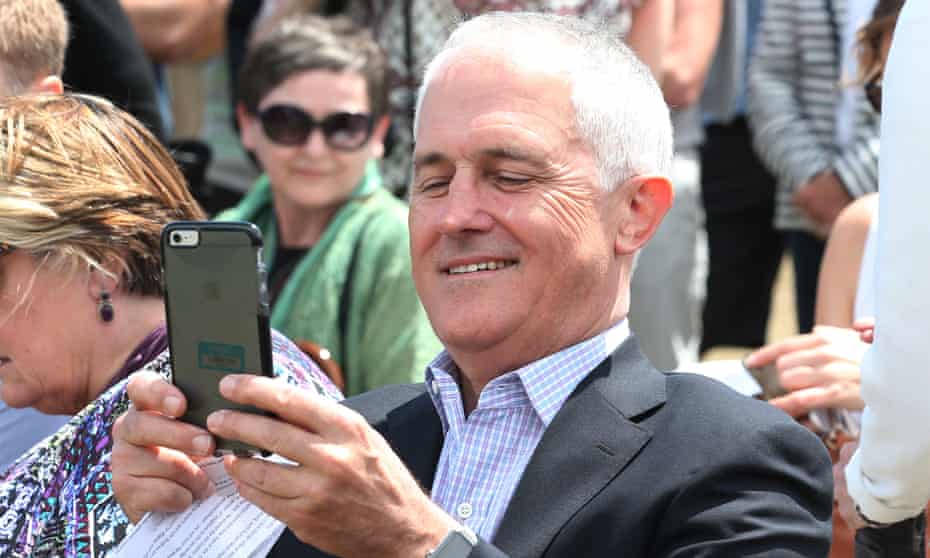 Malcolm Turnbull takes a photograph with his phone 