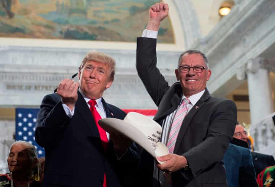 US President Donald Trump holds up a pen after signing the hat of Bruce Adams, chairman of the San Juan County Commission, after signing a presidential proclamation shrinking Bears Ears and Grand Staircase-Escalante national monuments at the Utah State Capitol in Salt Lake City, Utah.