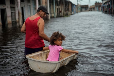 a man carrying a girl in a boat