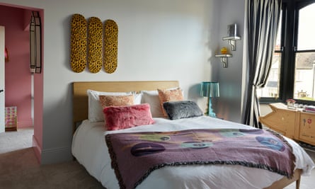 Neil and Daisy’s bedroom, skateboard-deck artworks and a Kartell Bourgie lamp beside the bed.