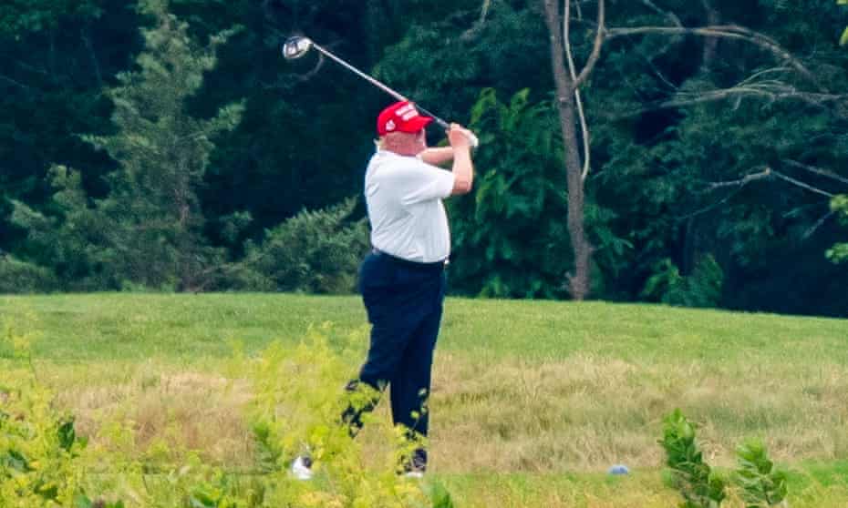 Trump golfs at his course in Sterling, Virginia.