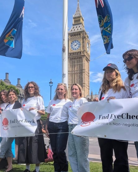 A group of women in white T-shirts pose with a banner in front of Big Ben.